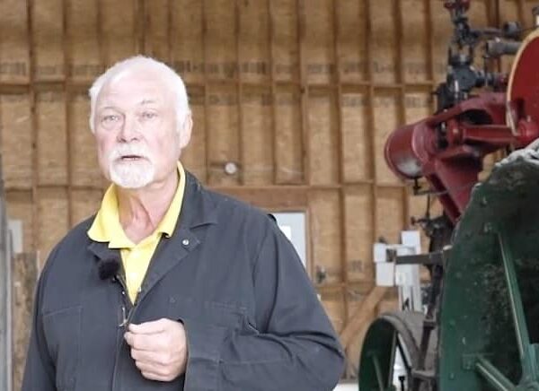 Man in Sugar Barn explaining how to make Maple Syrup