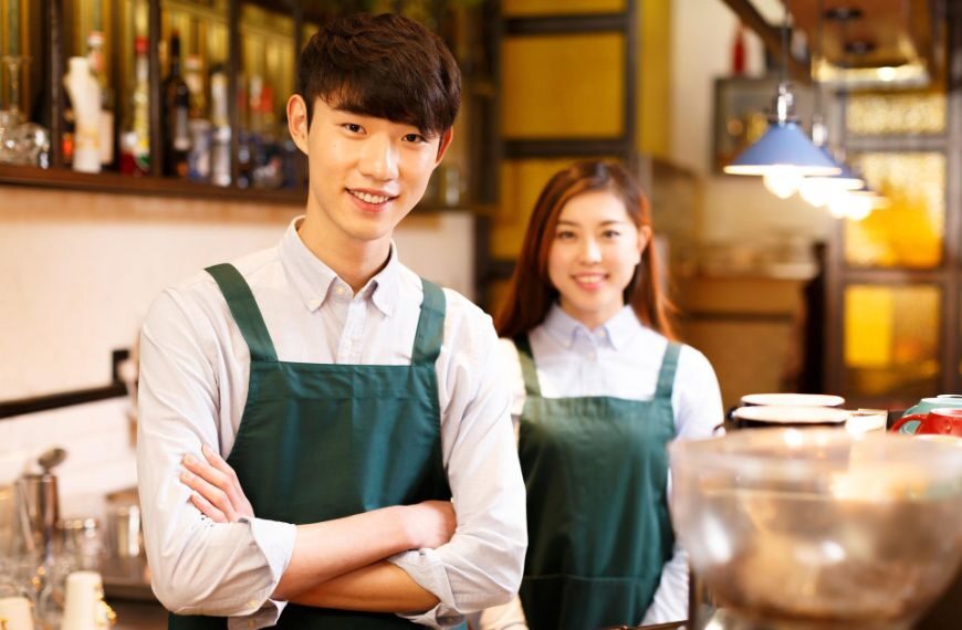 Two employees working in a coffee shop