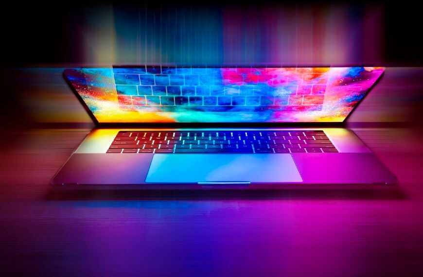 laptop glowing with colors of the rainbow.